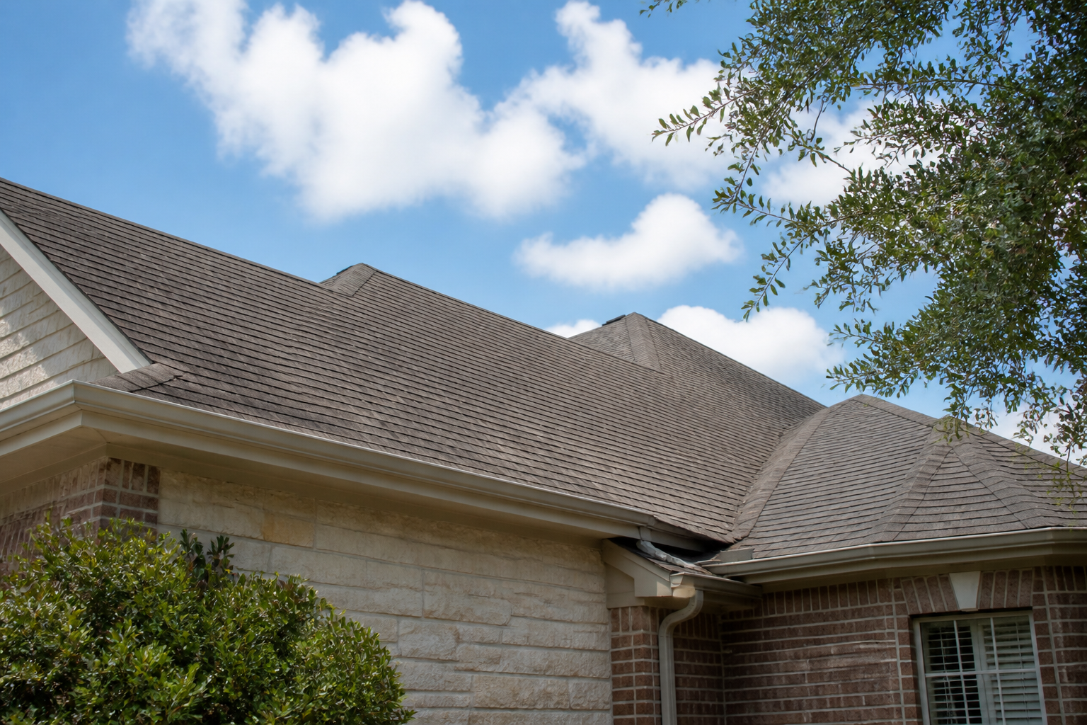 The roof of a residential home in San Antonio on a sunny day, ready for the roof rejuvenation process.